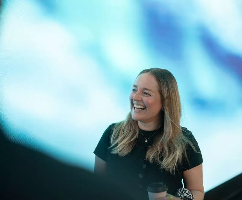 Lady smiling in front of bright lights