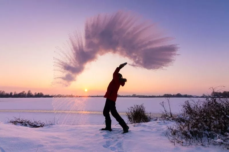 Person throwing snow in the air